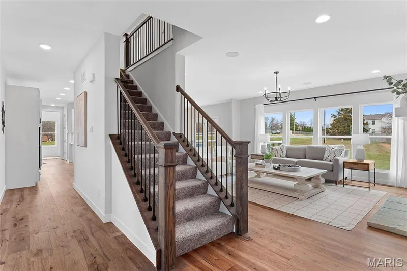 Stairway featuring hardwood / wood-style flooring, recessed lighting, and a chandelier — 1 TBB Bridgeport @ Chateau De Fond Du Lac, Lake St. Louis, MO 63367