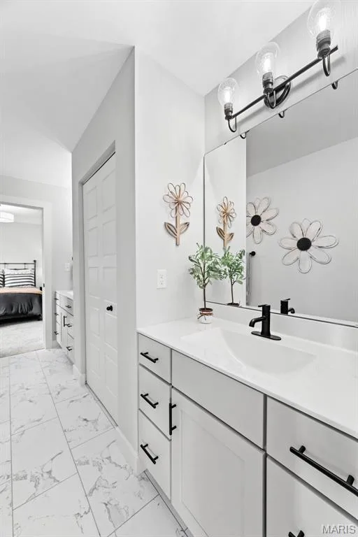 Ensuite bathroom featuring light marble finish flooring and vanity — 1 TBB Bridgeport @ Chateau De Fond Du Lac, Lake St. Louis, MO 63367