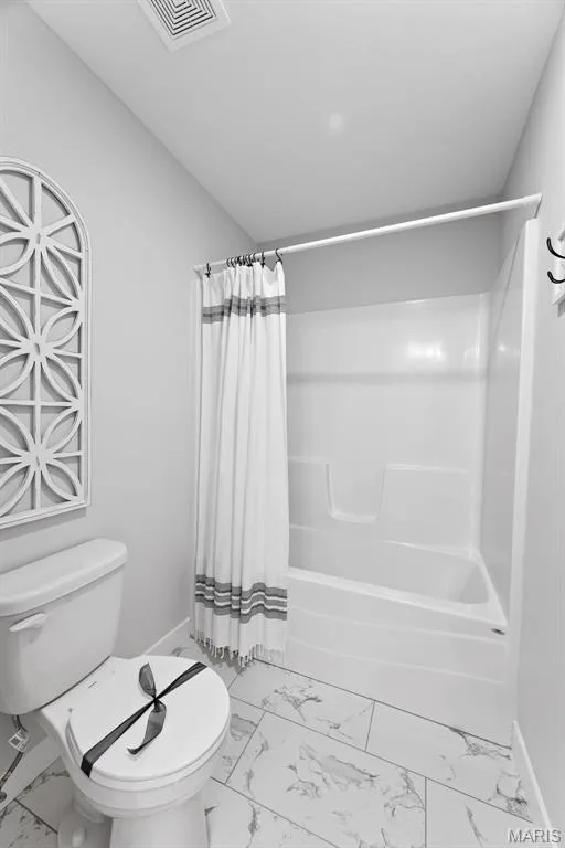 Bathroom featuring marble look tile flooring and shower / tub combo — 1 TBB Bridgeport @ Chateau De Fond Du Lac, Lake St. Louis, MO 63367