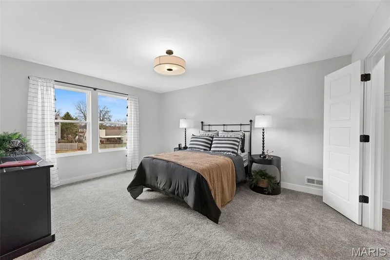 Bedroom with light carpet and baseboards — 1 TBB Bridgeport @ Chateau De Fond Du Lac, Lake St. Louis, MO 63367