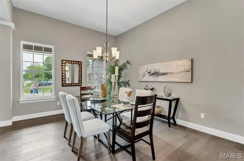 Dining room featuring wood finished floors and a chandelier — 1 TBB Monaco @ Chateau De Fond Du Lac, Lake St. Louis, MO 63367