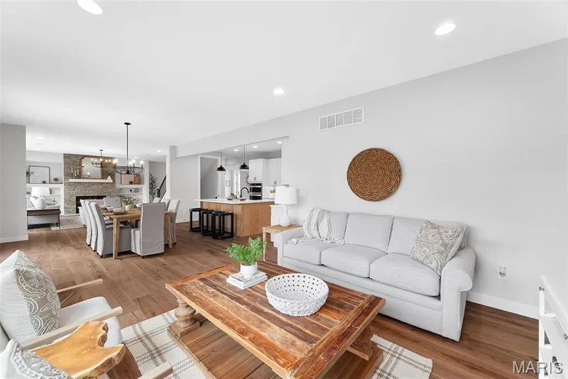 Living area with light wood-type flooring, recessed lighting, and a chandelier — 1 TBB Bridgeport @Willow Grove, Dardenne Prairie, MO 63368