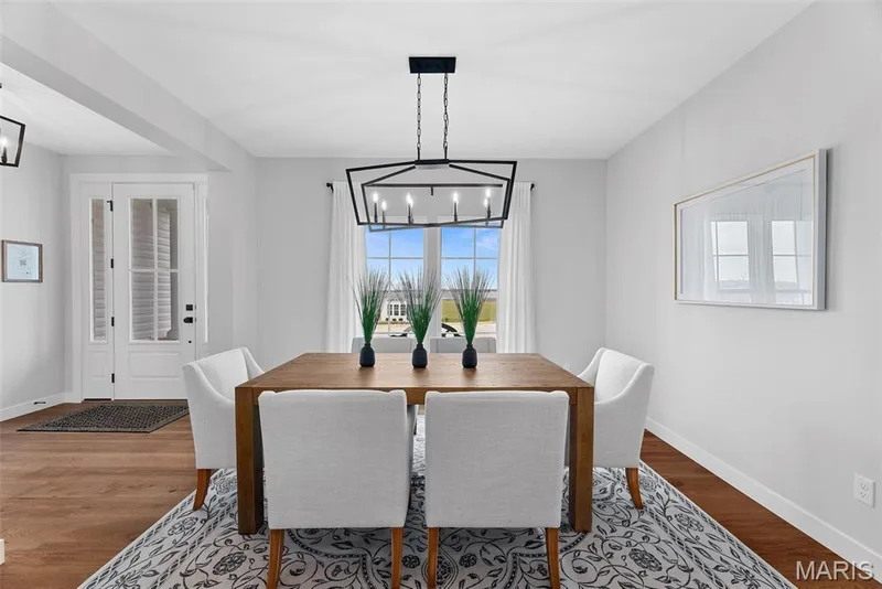 Dining area featuring a chandelier and wood finished floors — 1 TBB Bridgeport @Willow Grove, Dardenne Prairie, MO 63368