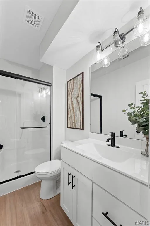 Full bath featuring vanity, light wood finished floors, and a stall shower — 1 TBB Bridgeport @Willow Grove, Dardenne Prairie, MO 63368