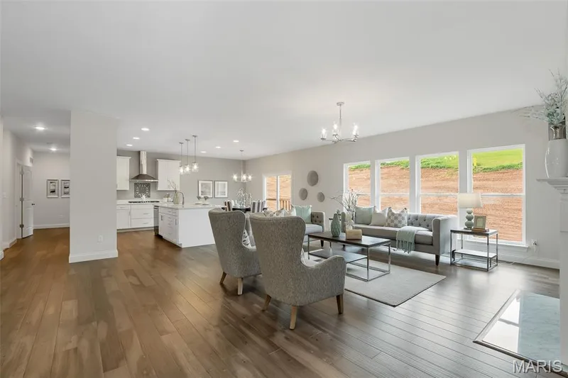 Living area featuring a chandelier, dark wood-style flooring, and recessed lighting — 1 TBB Waverly @ Chateau De Fond Du Lac, Lake St. Louis, MO 63367