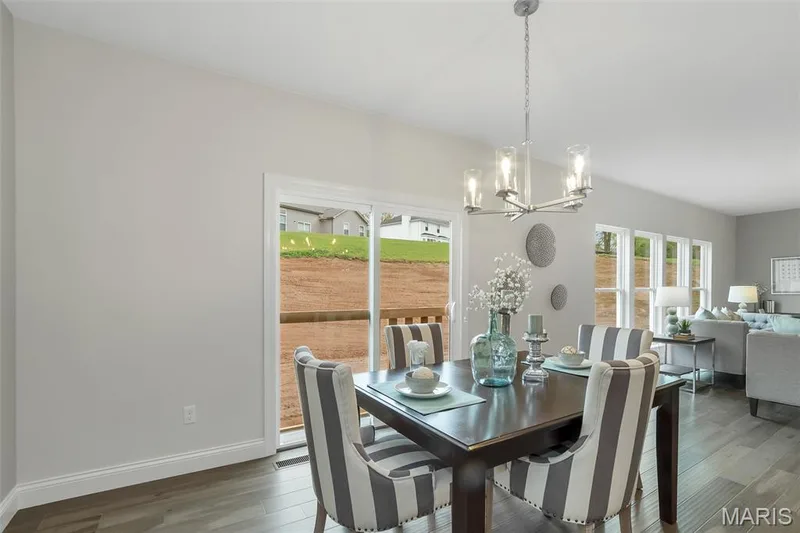 Dining area with a chandelier and dark wood-type flooring — 1 TBB Waverly @ Chateau De Fond Du Lac, Lake St. Louis, MO 63367