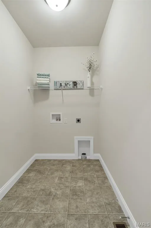 Laundry area featuring hookup for an electric dryer, light tile patterned floors, and hookup for a washing machine — 1 TBB Waverly @ Chateau De Fond Du Lac, Lake St. Louis, MO 63367