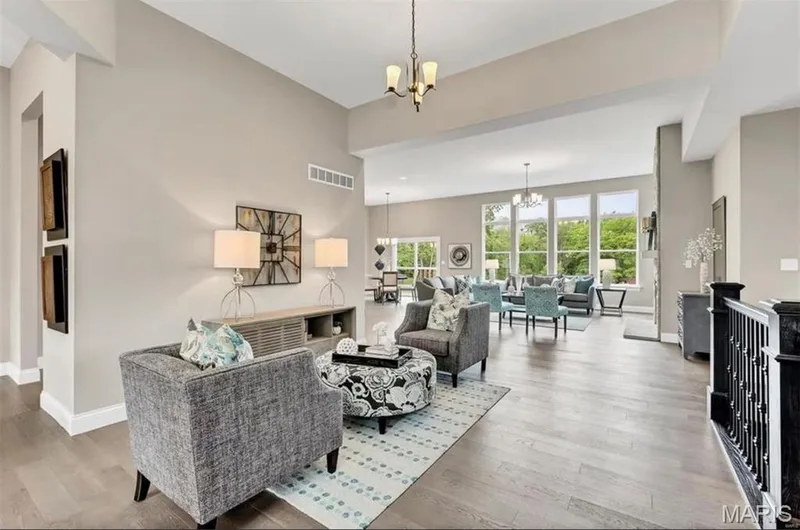 Living area featuring a chandelier and light wood-style floors — 1 TBB Monaco @Willow Grove, Dardenne Prairie, MO 63368