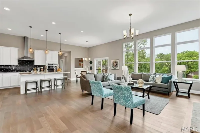 Living area featuring a chandelier, light wood-style floors, and recessed lighting — 1 TBB Monaco @Willow Grove, Dardenne Prairie, MO 63368