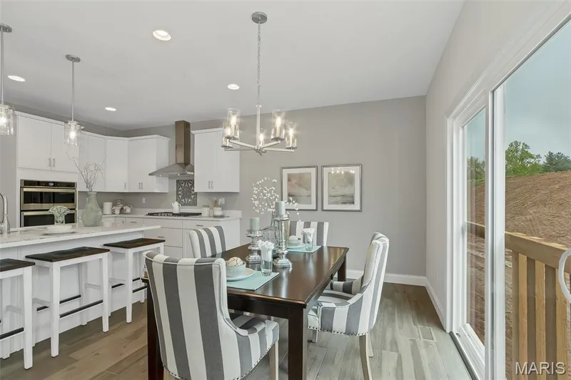 Dining room with dark wood finished floors, a chandelier, and recessed lighting — 1 TBB Waverly @Willow Grove, Dardenne Prairie, MO 63368