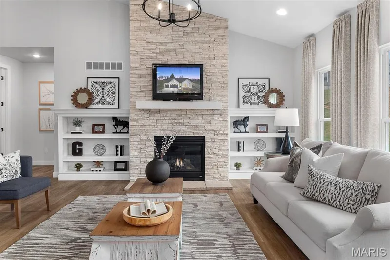 Living area with recessed lighting, a fireplace, lofted ceiling, and wood finished floors — 1 TBB Canterbury@ Willow Grove, Dardenne Prairie, MO 63368