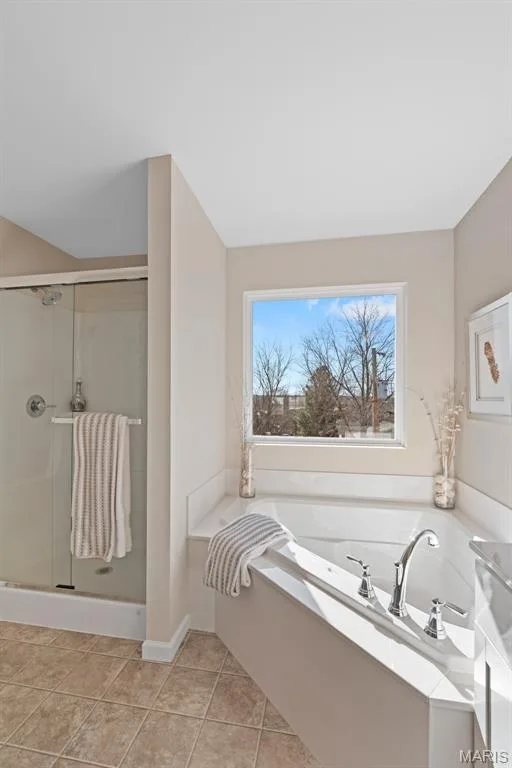 Full bath with plenty of natural light, a garden tub, a stall shower, and light tile patterned floors — 1 TBB Princeton @Willow Grove, Dardenne Prairie, MO 63368