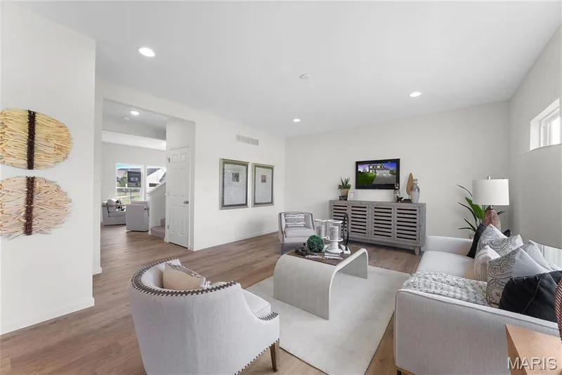 Living room with healthy amount of natural light, wood finished floors, and recessed lighting — 1 TBB Barkley @ Creekside Sommers, O'Fallon, MO 63367