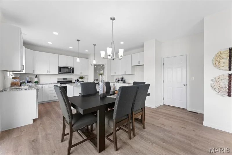 Dining room featuring a chandelier, light wood-style floors, and recessed lighting — 1 TBB Barkley @ Creekside Sommers, O'Fallon, MO 63367