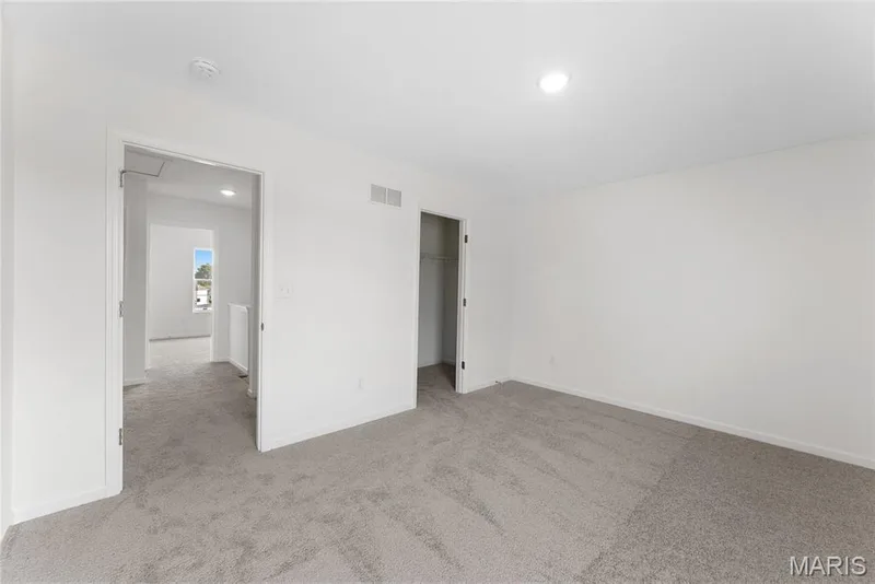 Unfurnished bedroom with light colored carpet, a walk in closet, and recessed lighting — 1 TBB Barkley @ Creekside Sommers, O'Fallon, MO 63367