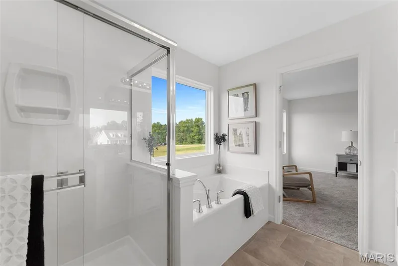 Bathroom featuring a stall shower, a garden tub, carpet floors, and tile patterned floors — 1 TBB Barkley @ Creekside Sommers, O'Fallon, MO 63367