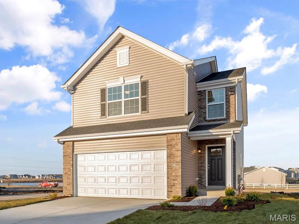 Traditional home with brick siding, an attached garage, and a shingled roof — 15 Integrity Court, O'Fallon, MO 63385