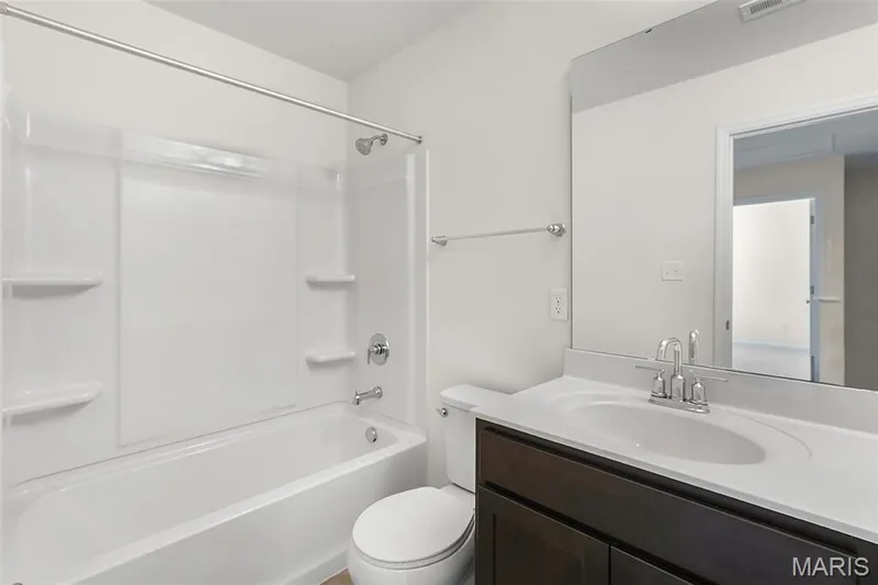 Bathroom featuring vanity and bathing tub / shower combination — 15 Integrity Court, O'Fallon, MO 63385