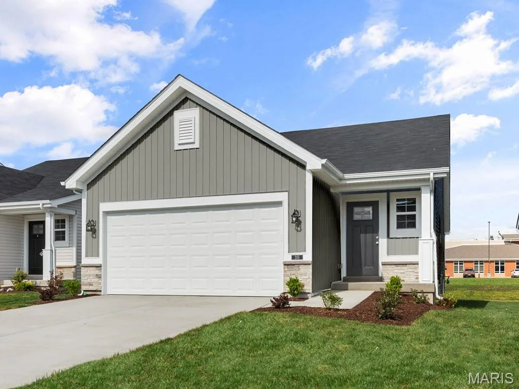 Ranch-style house with a garage, concrete driveway, a porch, and board and batten siding — 19 Integrity Court, O'Fallon, MO 63385