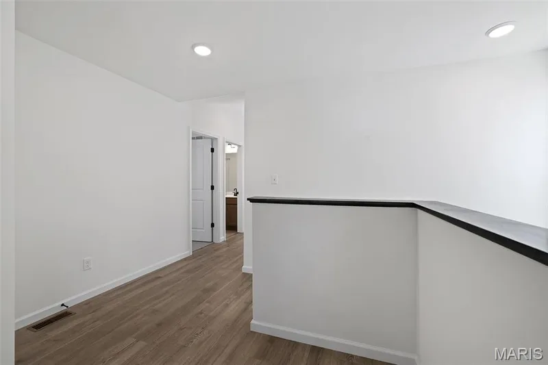 Hallway with wood finished floors and recessed lighting — 19 Integrity Court, O'Fallon, MO 63385