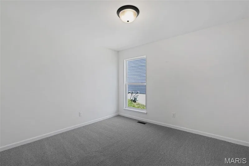 Carpeted empty room featuring baseboards — 19 Integrity Court, O'Fallon, MO 63385