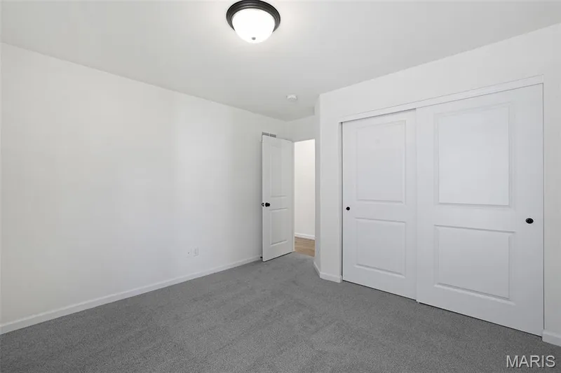 Unfurnished bedroom with carpet flooring and a closet — 19 Integrity Court, O'Fallon, MO 63385