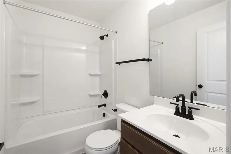 Full bathroom featuring vanity and  shower combination — 19 Integrity Court, O'Fallon, MO 63385