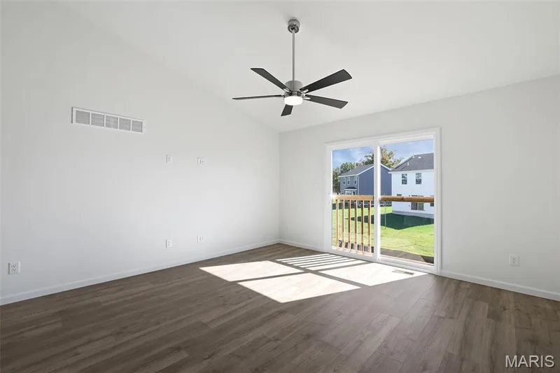 Spare room featuring vaulted ceiling, dark wood-type flooring, and ceiling fan — 19 Integrity Court, O'Fallon, MO 63385