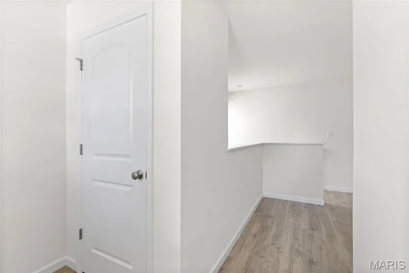 Hall featuring baseboards and light wood-style floors — 46 Integrity Court, O'Fallon, MO 63385
