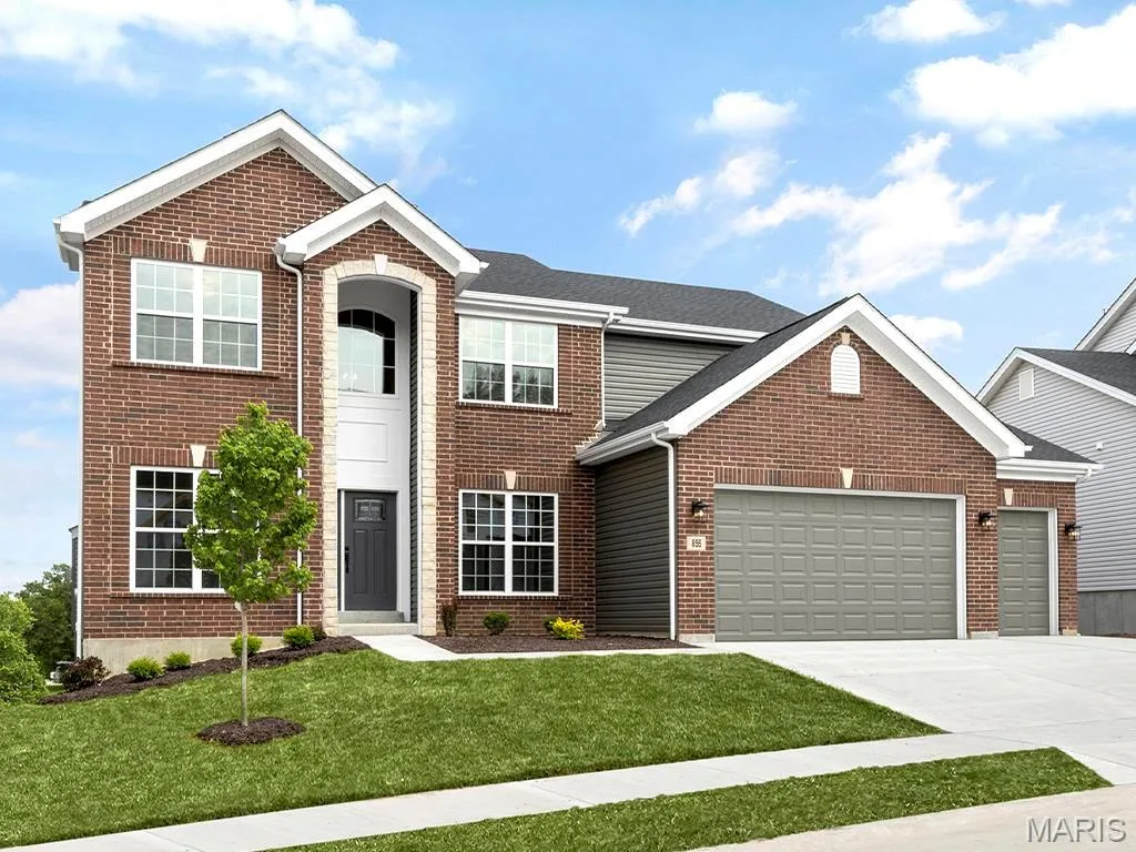 View of front of home with a garage and a front yard — 3 Sequoia at Bluestem Estates, St Charles, MO 63367