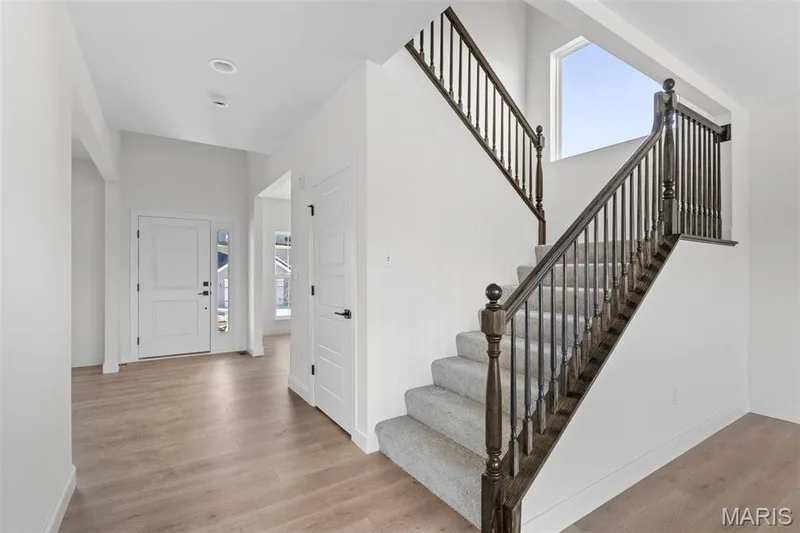 Entryway with light hardwood / wood-style floors — 3 Sequoia at Bluestem Estates, St Charles, MO 63367