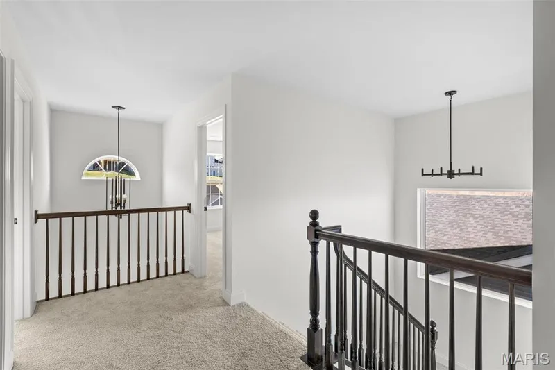 Corridor featuring a chandelier and light colored carpet — 3 Sequoia at Bluestem Estates, St Charles, MO 63367