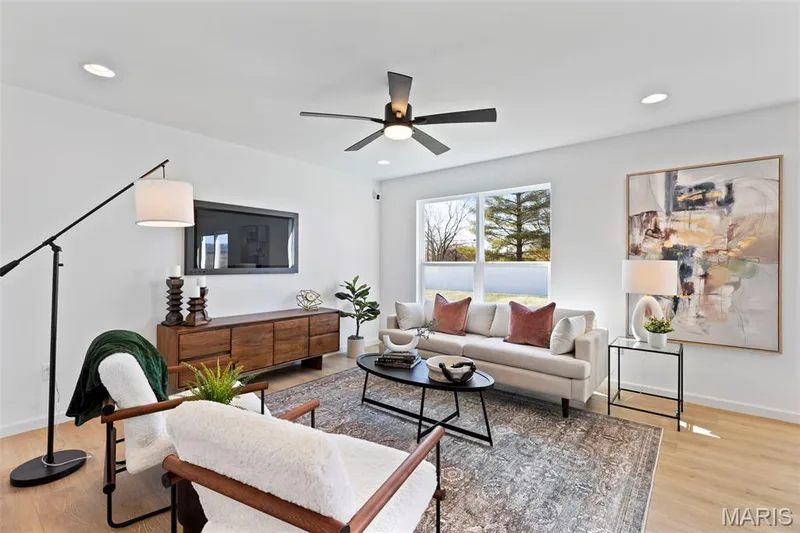Living room featuring light wood-style floors, ceiling fan, and recessed lighting — 3 Sterling at Westhaven, Wentzville, MO 63385