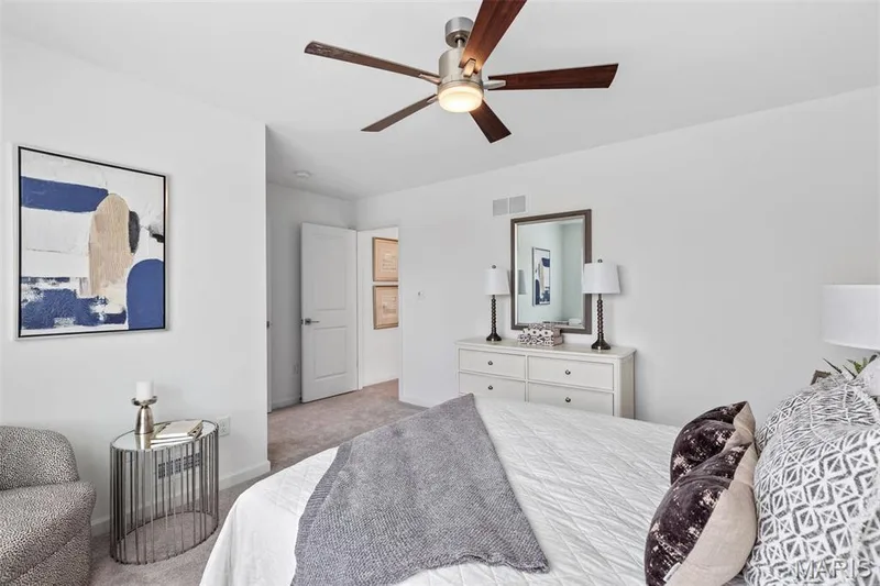 Bedroom featuring ceiling fan and light carpet — 3 Ashford at Elm Crossing, St Charles, MO 63301