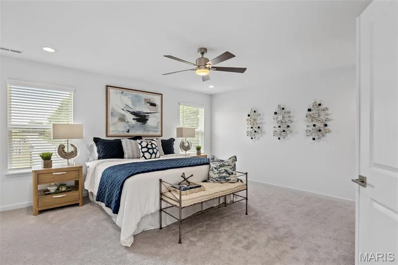 Bedroom with ceiling fan and light colored carpet — 3 Ashford at Elm Crossing, St Charles, MO 63301