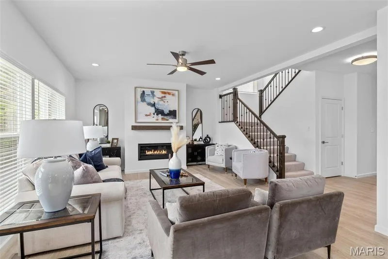 Living room with light wood-type flooring and ceiling fan — 3 Ashford at Elm Crossing, St Charles, MO 63301