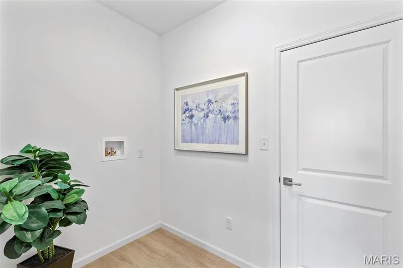 Washroom featuring washer hookup and hardwood / wood-style floors — 3 Ashford at Elm Crossing, St Charles, MO 63301