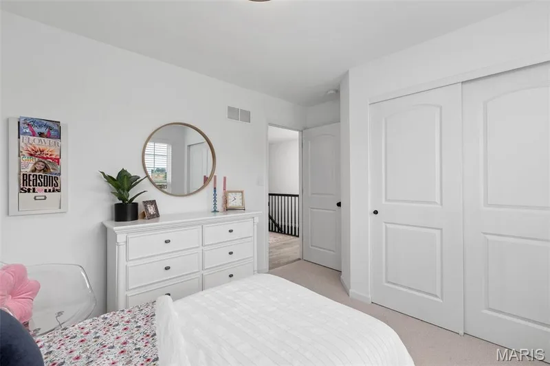 Carpeted bedroom with a closet — 3 Aspen at Elm Crossing, St Charles, MO 63301