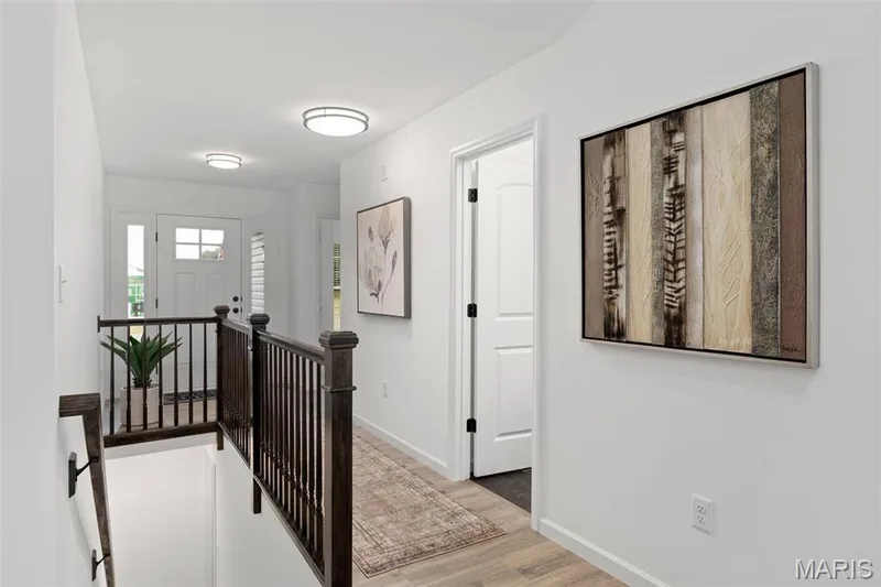Corridor featuring light hardwood / wood-style floors — 3 Aspen at Elm Crossing, St Charles, MO 63301