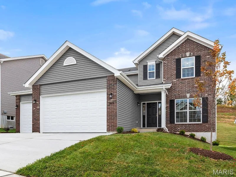 Traditional home with brick siding, driveway, a garage, and a front lawn — 225 Windmill View Drive, O'Fallon, MO 63385