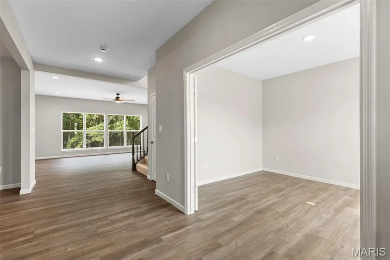 Empty room with recessed lighting, light wood-style flooring, stairway, and a ceiling fan — 225 Windmill View Drive, O'Fallon, MO 63385