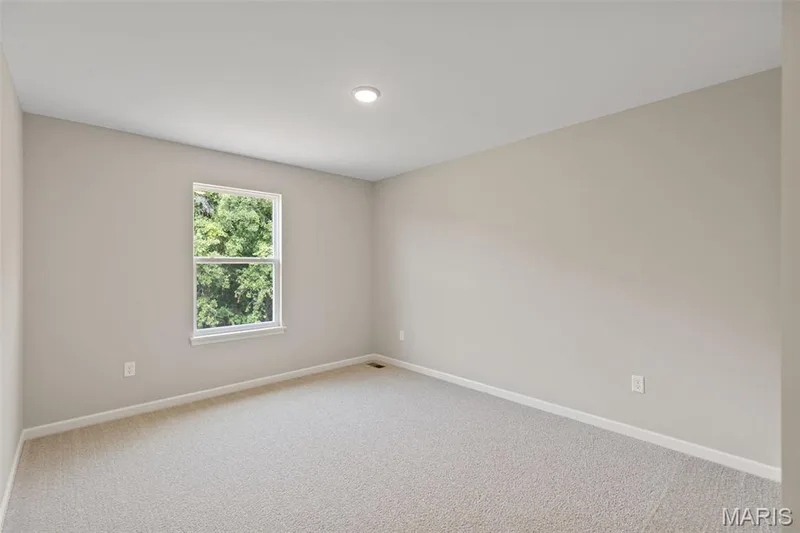 Carpeted spare room featuring baseboards — 225 Windmill View Drive, O'Fallon, MO 63385