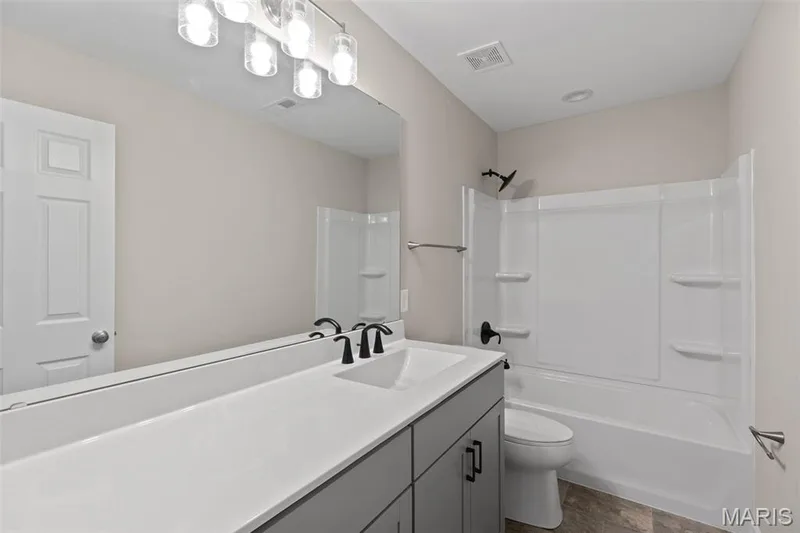 Full bathroom featuring vanity and shower / washtub combination — 225 Windmill View Drive, O'Fallon, MO 63385