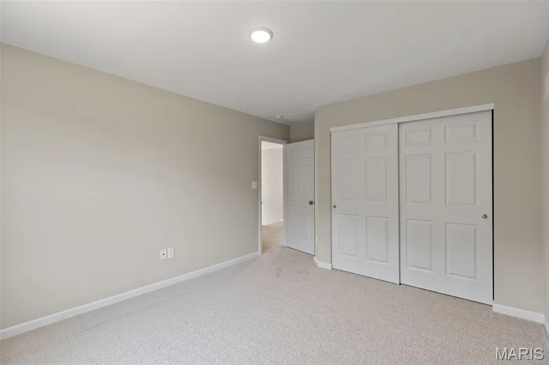Unfurnished bedroom with light colored carpet and a closet — 225 Windmill View Drive, O'Fallon, MO 63385