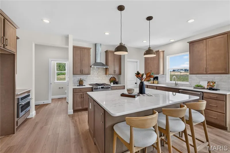 Gourmet Kitchen with Stainless steel gas appliances and Quartz countertops — 431 Oak Barrel Drive, O'Fallon, MO 63385