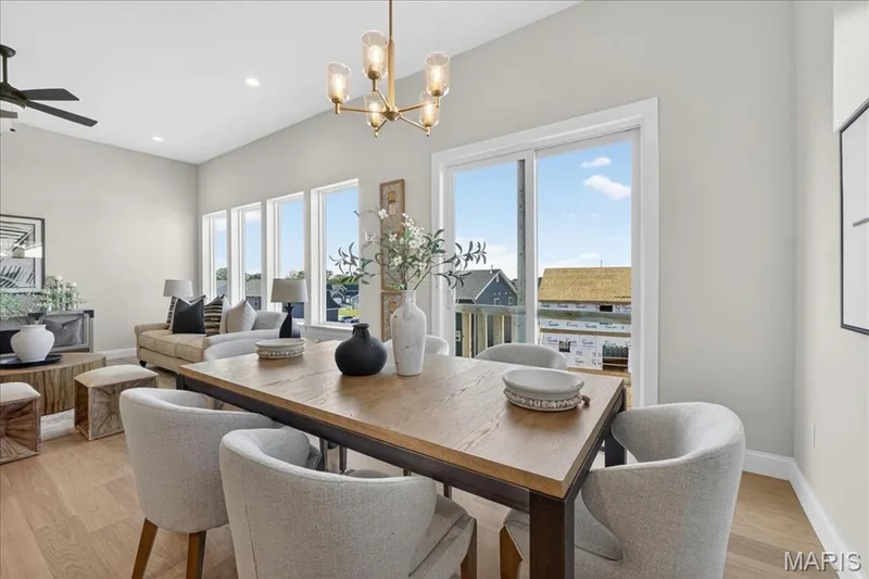 Breakfast area with view of window wall in Great Room and sliding patio door — 421 Farmhouse Drive, O'Fallon, MO 63385