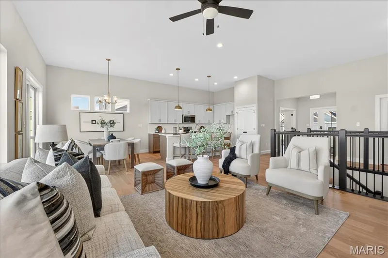 Great Room with view of stairwell, and Kitchen/Breakfast area — 421 Farmhouse Drive, O'Fallon, MO 63385