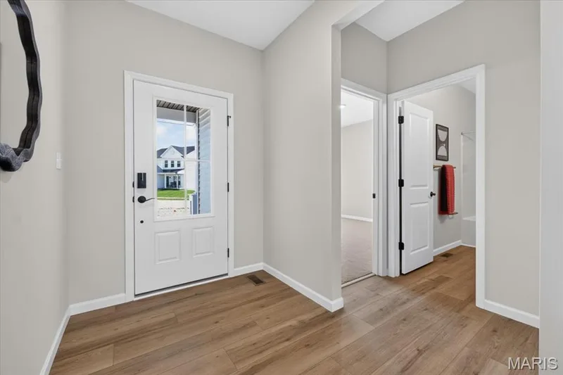A light-filled foyer welcomes you home with clean sightlines, thoughtful architectural details, and an open flow that connects effortlessly to the main living areas. — 86 River Wind Drive, St Charles, MO 63301