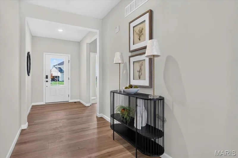 Step into a bright, welcoming foyer that creates an inviting first impression and provides a seamless transition into the home's open-concept living spaces. — 86 River Wind Drive, St Charles, MO 63301