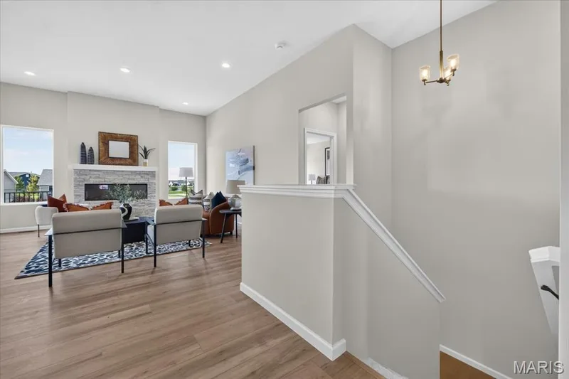 A bright and welcoming foyer sets the tone for the home with luxury vinyl plank flooring, soaring ceilings, recessed lighting, and a seamless flow into the expansive great room, creating an impressive first impression for family and guests alike. — 86 River Wind Drive, St Charles, MO 63301